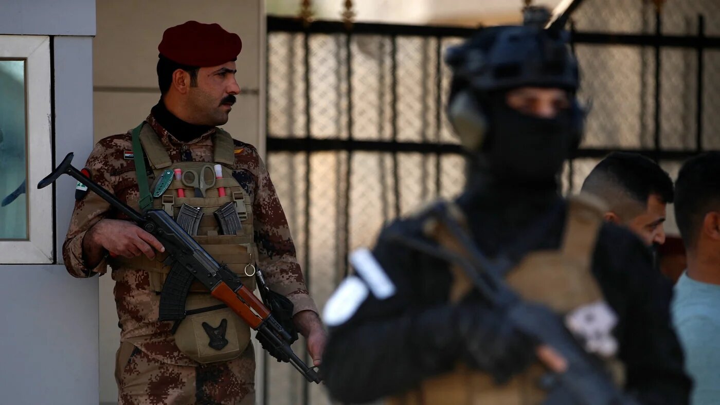 A paramilitary of the Hashed al-Shaabi (Popular Mobilisation) forces stands guard during the funeral of a comrade, who died in American air strikes targeting Iran-backed groups the day before, in Baghdad on 25 January 2024 (Ahmed Al-Rubaye/AFP)