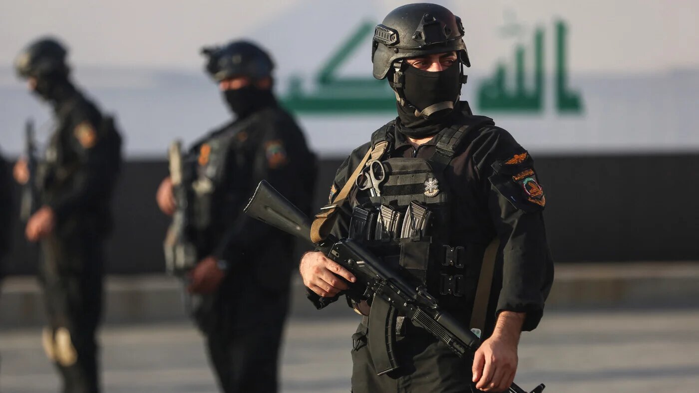 Popular Mobilisation Forces stand guard during a symbolic funeral procession honouring those killed in US-Israeli attacks and celebrating the withdrawal of the US-led coalition from Iraq, in Baghdad on 1 October 2026 (Ahmad al-Rubaye/AFP)
