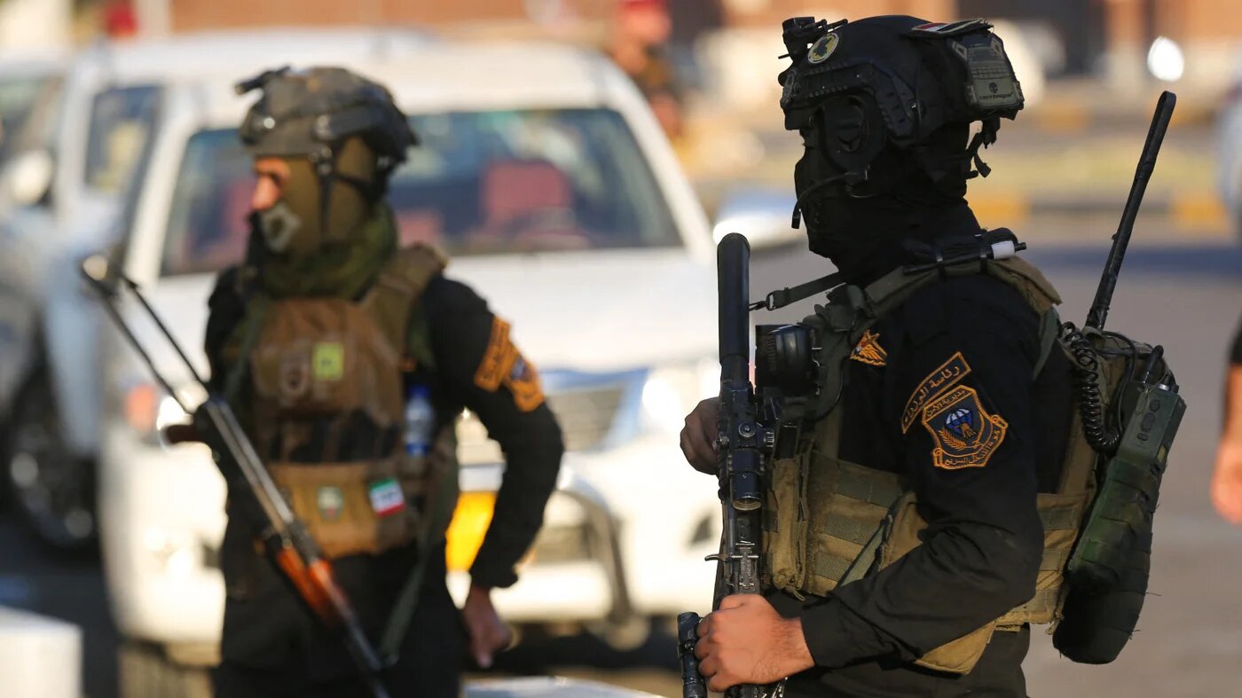 Members of Iraq's special forces stand guard during a symbolic funeral procession towards one of the Green Zone entrances in the capital Baghdad, on 6 November 2021 (AFP)