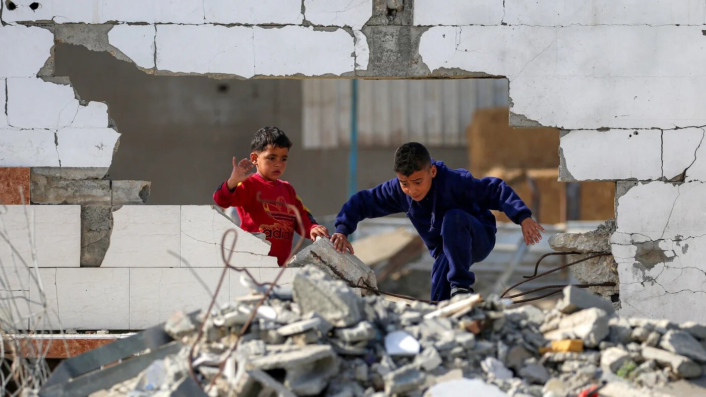 Palestinian children climb through rubble at the Maghazi refugee camp in the central Gaza Strip on 11 February, 2026 (AFP/Eyad Baba)