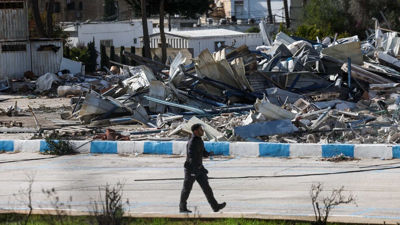 A member of the Israeli forces walks past the rubble of the demolished UN agency for Palestinian refugees (Unrwa) headquarters in East Jerusalem, 20 January, 2026 (Reuters/Ammar Awad)