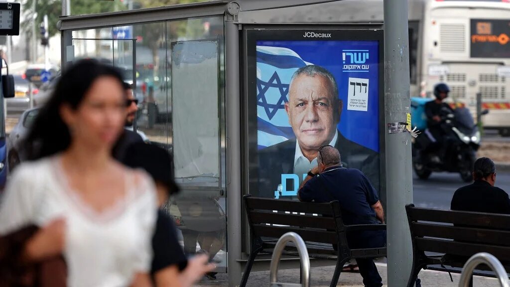 People walk past an election poster for Gadi Eisenkot, the former military chief and leader of the Yashar party, in Ramat Gan, Israel, on 15 October 2026 (Jack Guez/AFP)