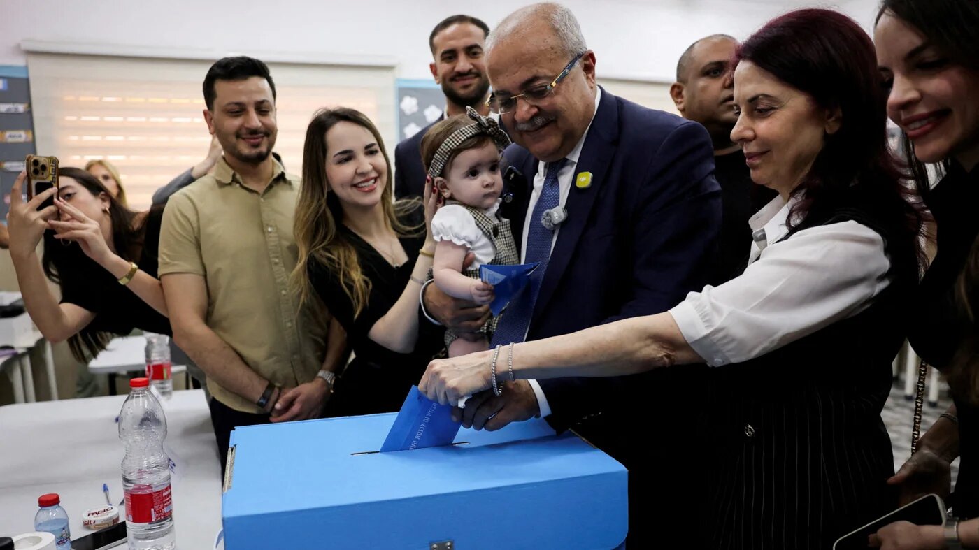 Palestinian candidate Ahmad Tibi of the Joint List party with his family votes during the national election, in the Arab village of Taibe, northern Israel, 27 October 2026 (Reuters/Ammar Awad)