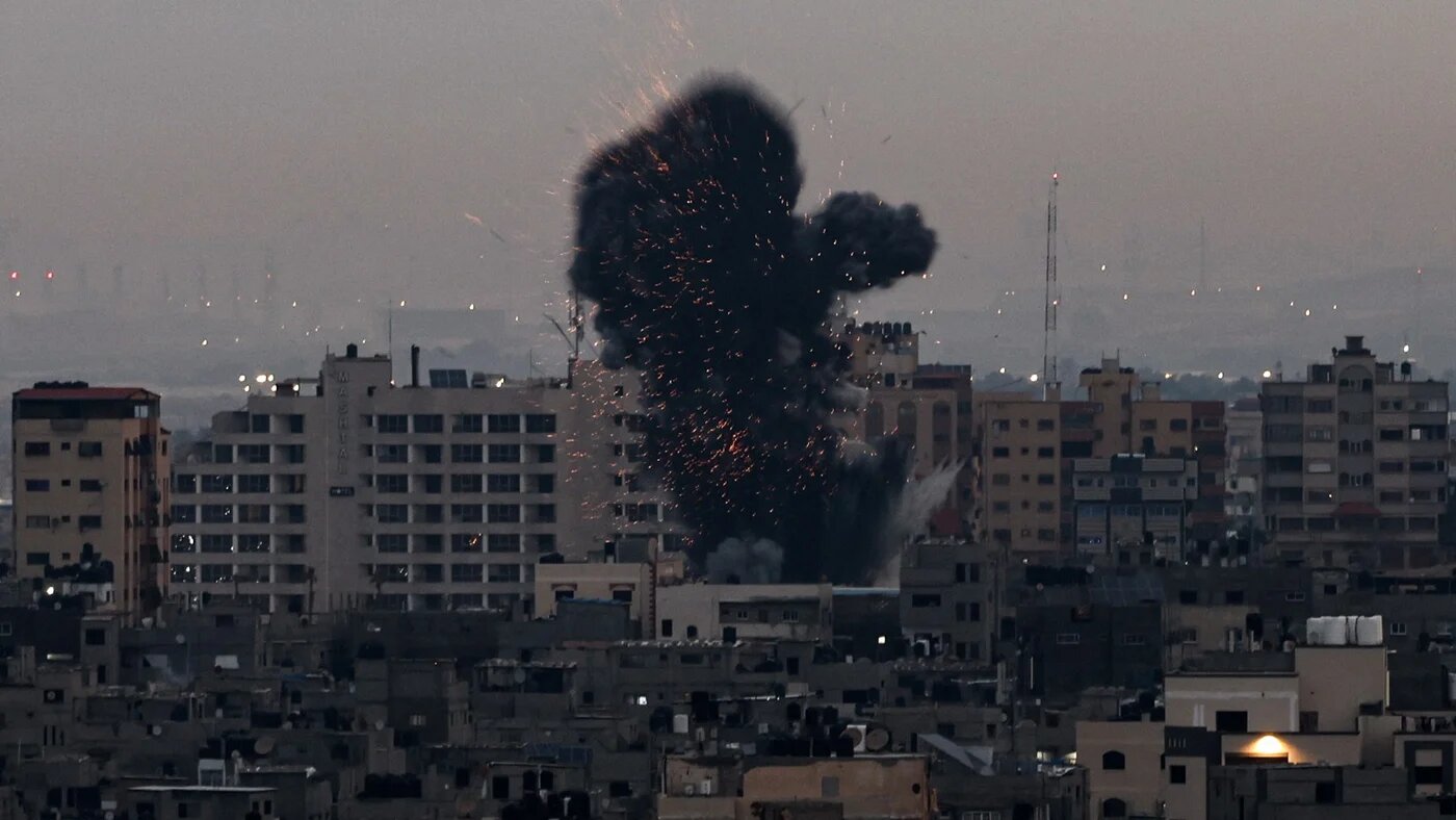 Smoke rises above buildings in Gaza City as Israel launched air strikes on the Palestinian enclave early on 23 February 2023 (AFP)