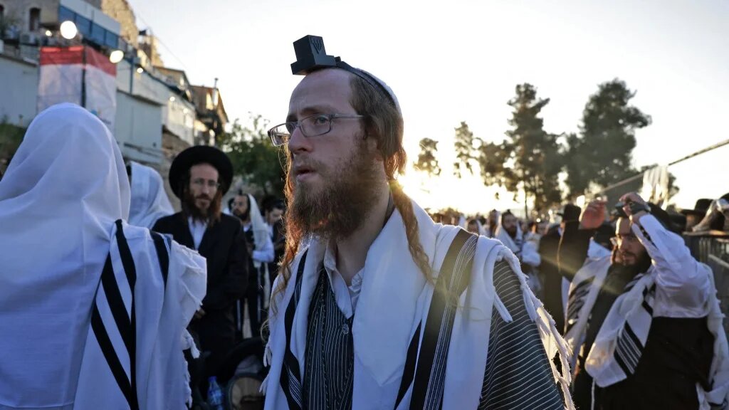 Ultra-Orthodox Jews pray during celebrations at the gravesite of Rabbi Shimon Bar Yochai in the northern Israeli village of Meron in the early hours of 19 May 2022 (AFP)