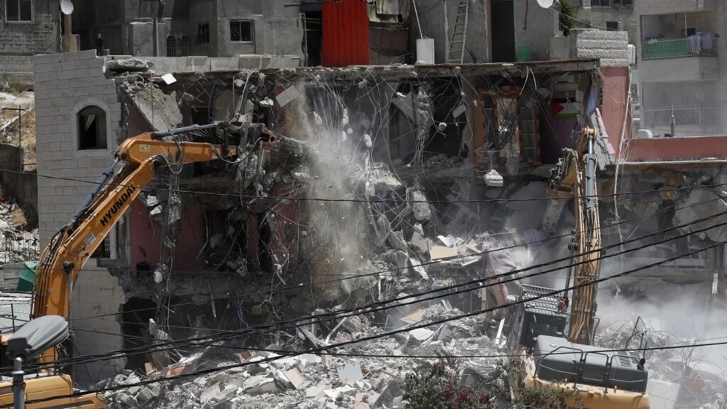 Des machines israéliennes démolissent une maison palestinienne dans le quartier arabe de Silwan à Jérusalem-Est le 10 mai 2022 (AFP/Ahmad Gharabli)
