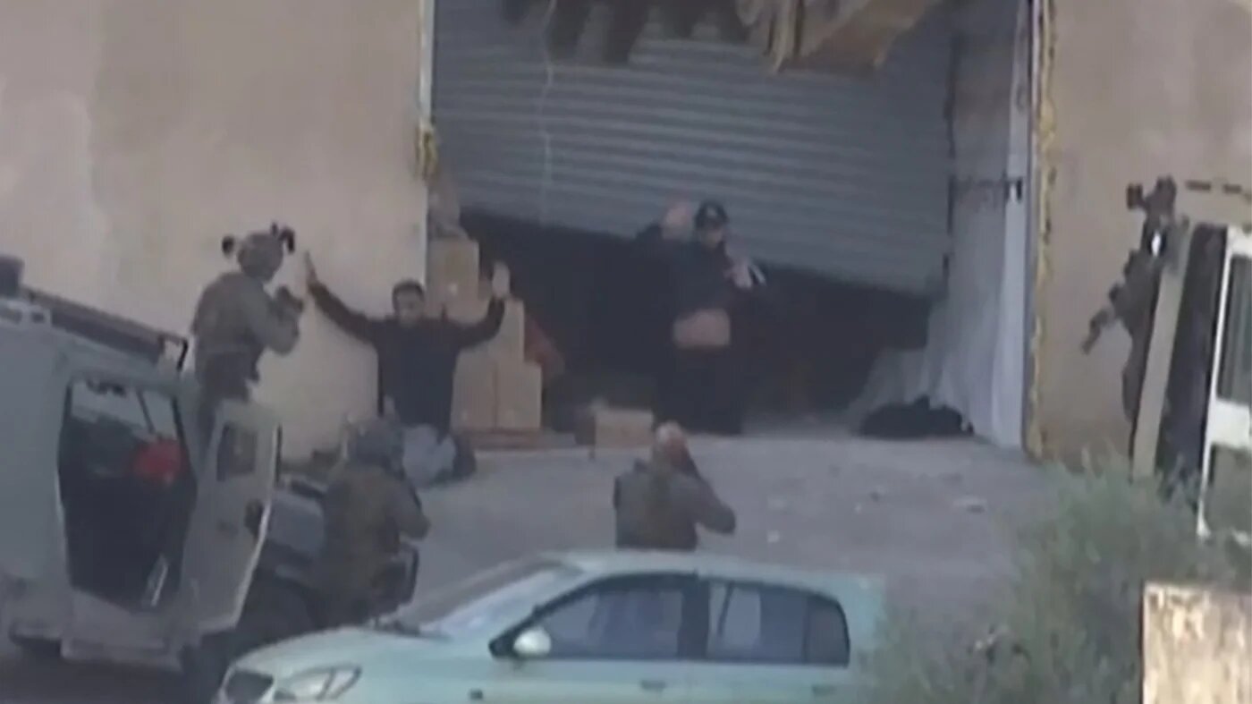Two Palestinian men surrendering before Israeli forces, moments before being shot dead during a military operation in Jenin, West Bank 27 November 2025 (AFP/Palestine TV)