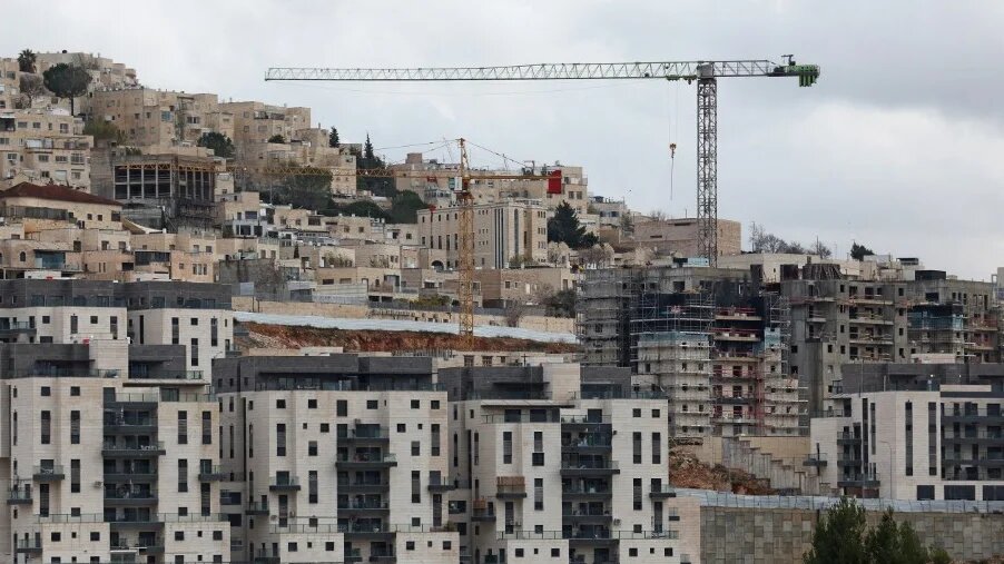 Construction cranes are pictured at Ramat Shlomo, an Israeli settlement in occupied East Jerusalem, on 7 February 2025 (Ahmad Gharabli/AFP)