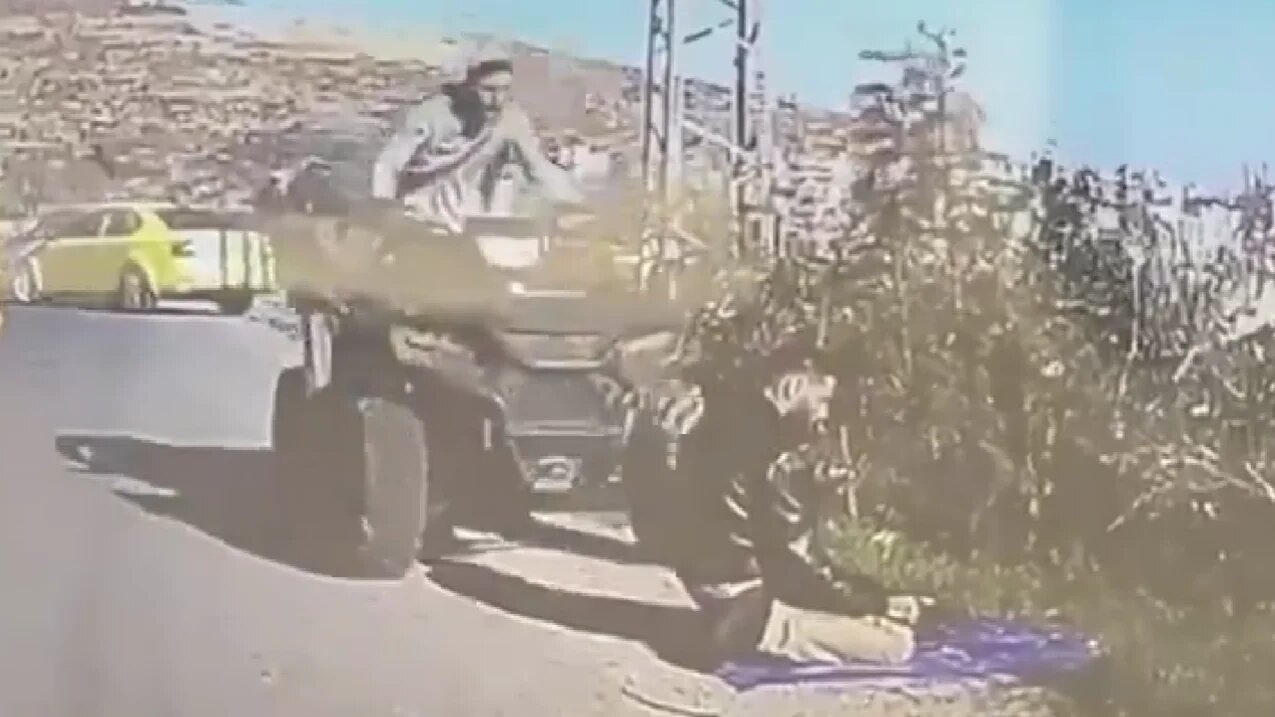 An armed settler is seen running over a Palestinian who was praying by the roadside in Ramallah, in the occupied West Bank (X/Screenshot)