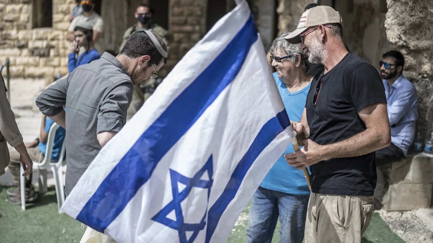 Israeli settlers celebrate the resettlement of the Palestinian village of Sanur, in the occupied West Bank, on 19 April, 2026 (Marco Longari/AFP)