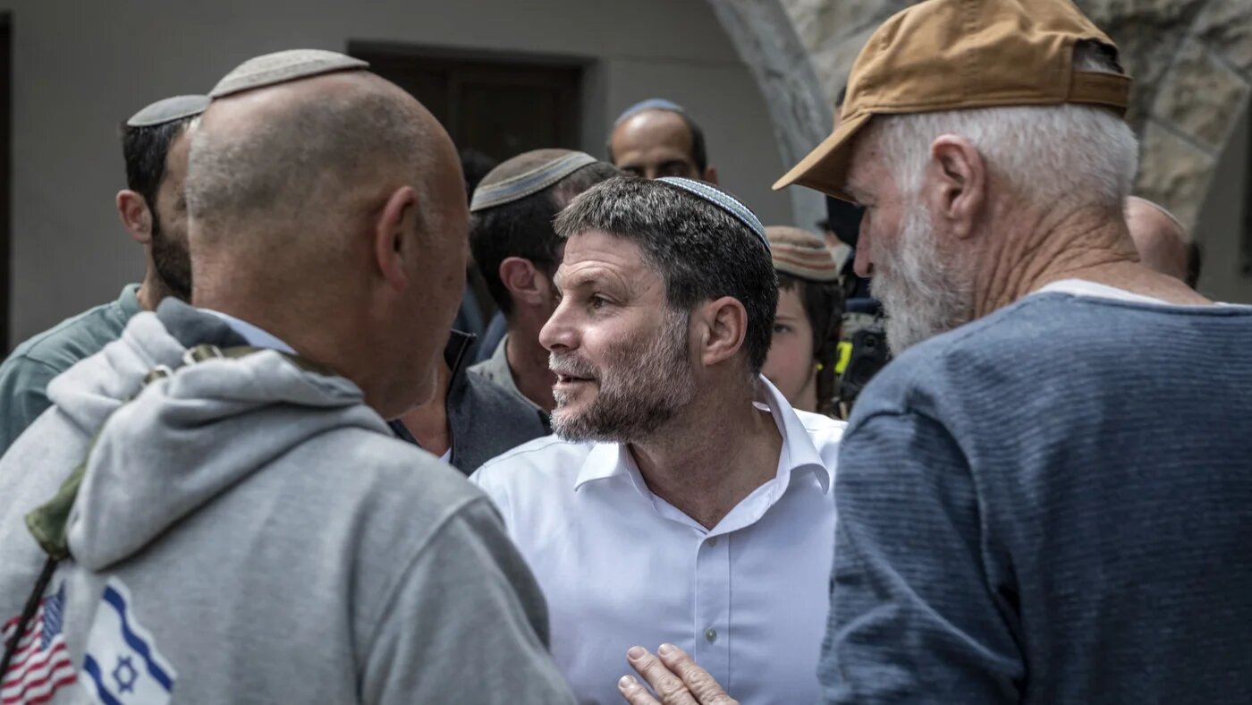 Israel's far-right Finance Minister Bezalel Smotrich (C) is surrounded by Israeli settlers at the end of the resettlement ceremony of Sa-Nur, south of Jenin, in the Israeli-occupied West Bank on April 19, 2026. Israel on April 19 began resettling Sa Nur, a West Bank settlement evacuated 20 years ago, with senior ministers marking the occasion with defiant declarations against Palestinian statehood and calls to resettle Gaza. MARCO LONGARI / AFP
