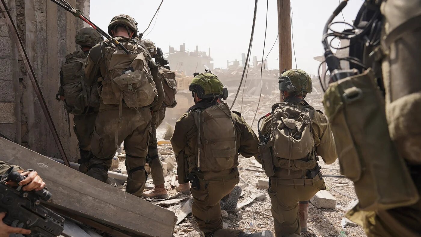This handout picture released by the Israeli army on 18 July 2024, shows Israeli soldiers in the Gaza Strip (AFP)
