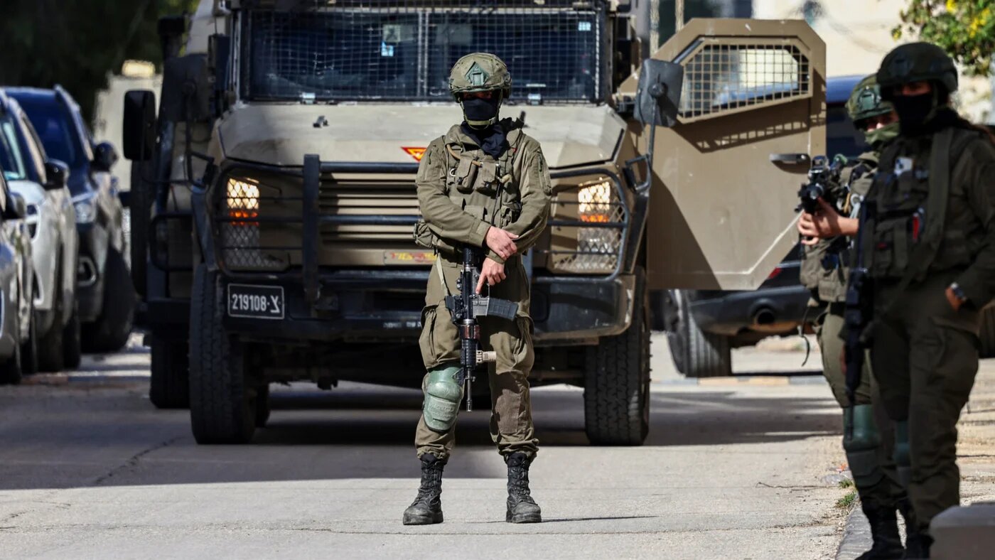 Israeli soldiers take positions during a raid in Ramallah in the occupied West Bank on 1 December 2025 (Zain Jaafar/AFP)