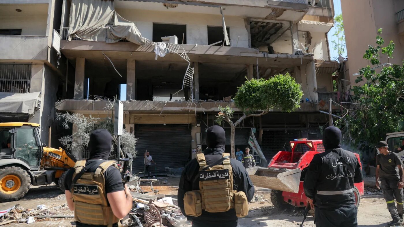 Lebanese army soldiers stand guard as people clear the rubble at the site of an Israeli air strike that targeted a building in Beirut’s southern suburbs on 14 June 2026 (Ibrahim Amro/AFP)