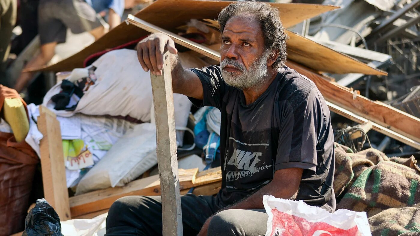 A Palestinian man sits amid rubble of a destroyed building following overnight Israeli bombardment on al-Shati refugee camp, west of Gaza City, on 12 September, 2025 (AFP/Omar al-Qattaa)