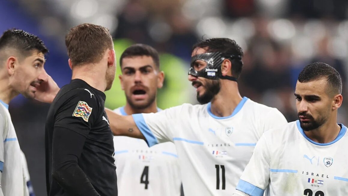  Israel's midfielder #22 Mahmoud Jaber, Israel's defender #11 Sagiv Jehezkel and Israel's defender #04 Raz Shlomo react during the UEFA Nations League League A, Group A2 football match between France and Israel at The Stade de France stadium in Saint-Denis, in the northern outskirts of Paris, on November 14, 2024. FRANCK FIFE / AFP