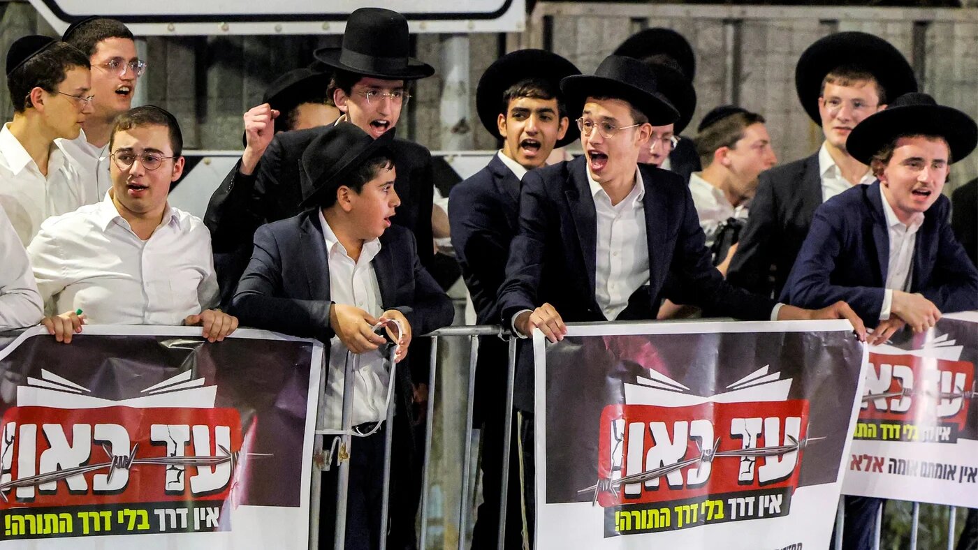 Ultra-Orthodox Jewish men protest the recent arrests of ultra-Orthodox draft dodgers, near Bet Lid military prison in Kfar Yona in central Israel on 24 June 2026 (Jack Guez/AFP)