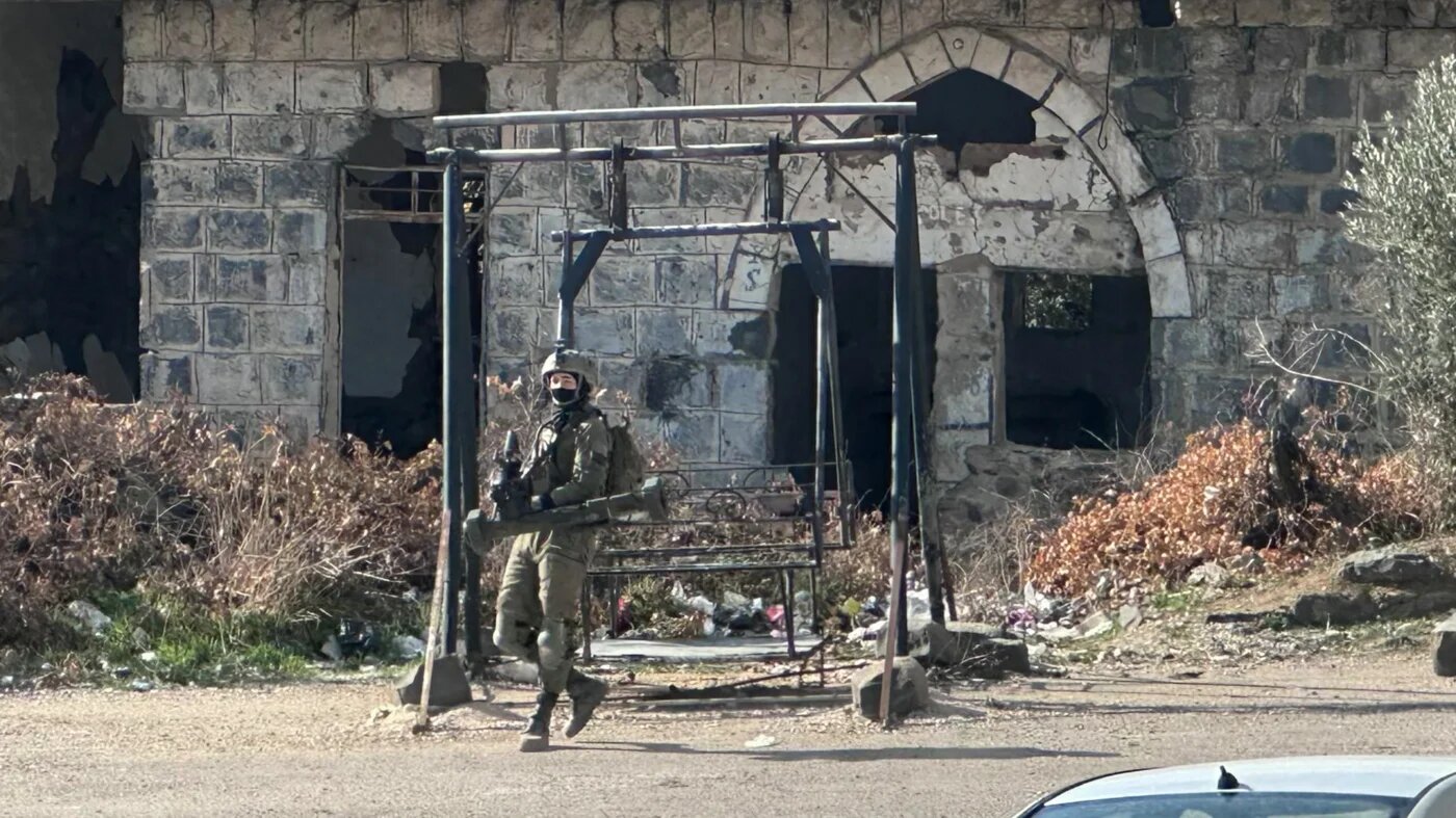 An Israeli soldier takes a position in the Syrian town of Jubata al-Khashab, in the UN-patrolled buffer zone in the occupied Golan Heights on 20 December 2024 (Bakr Alkasem/AFP)