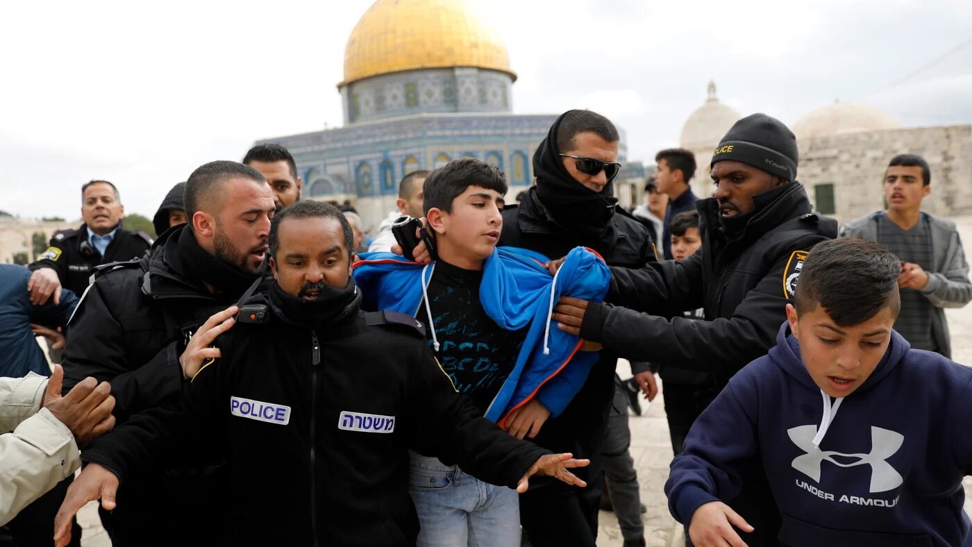 Israeli policemen detain a young Palestinian demonstrator after protesters tried to break the lock on a gate at the al-Aqsa mosque compound in Jerusalem's Old City on 18 February 2019 (AFP)