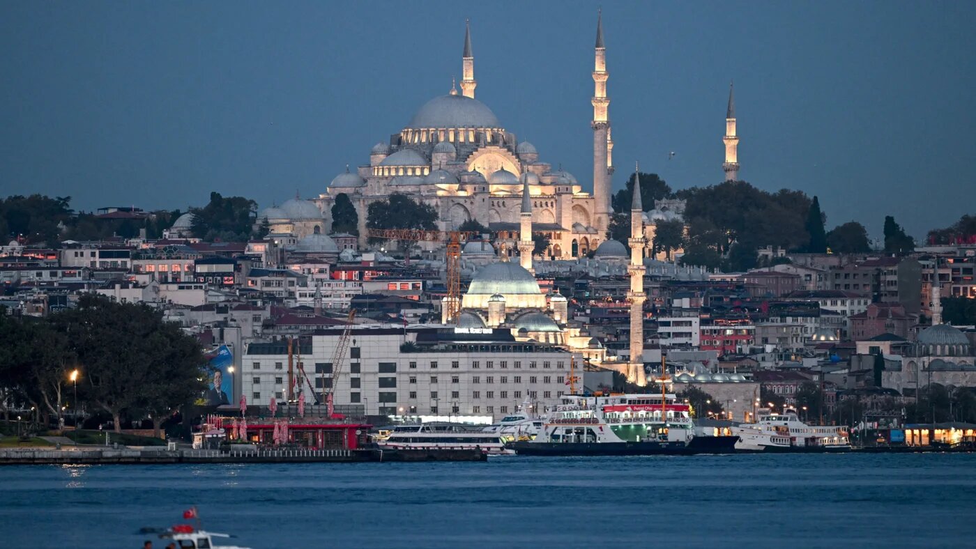 Fishermen fish on Bosphorus in Istanbul, on September 18, 2024 as Suleymaniye mosque is seen in the background (AFP)