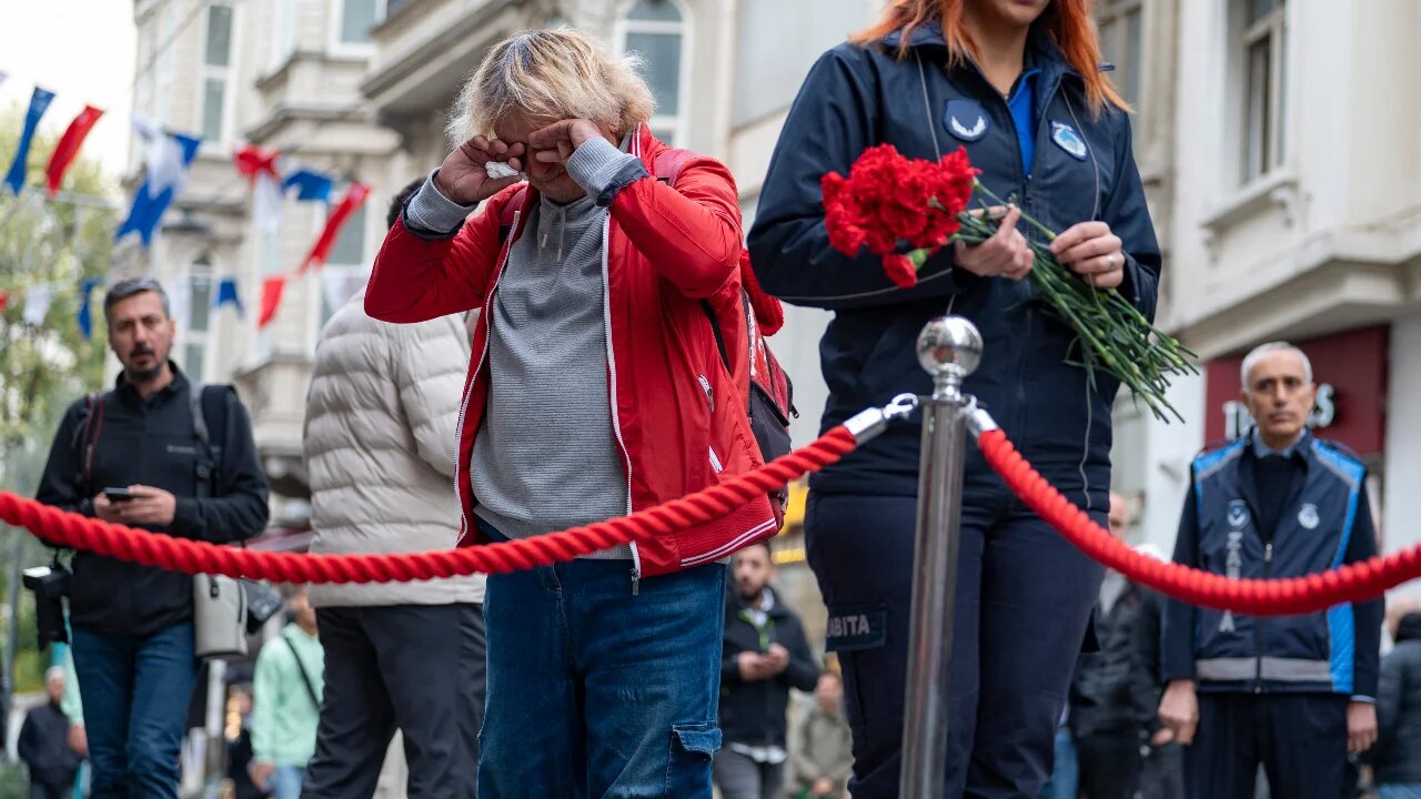 A person is seen grieving at a memorial for those killed and injured in the blast in Istiklal Avenue, Istanbul, on 14 November 2022 (AFP)
