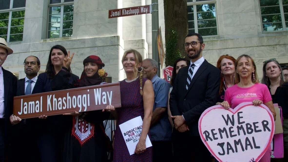 Activists gather around the new "Jamal Khashoggi Way" street sign after the renaming ceremony outside the Saudi embassy in Washington on 15 June 2022.