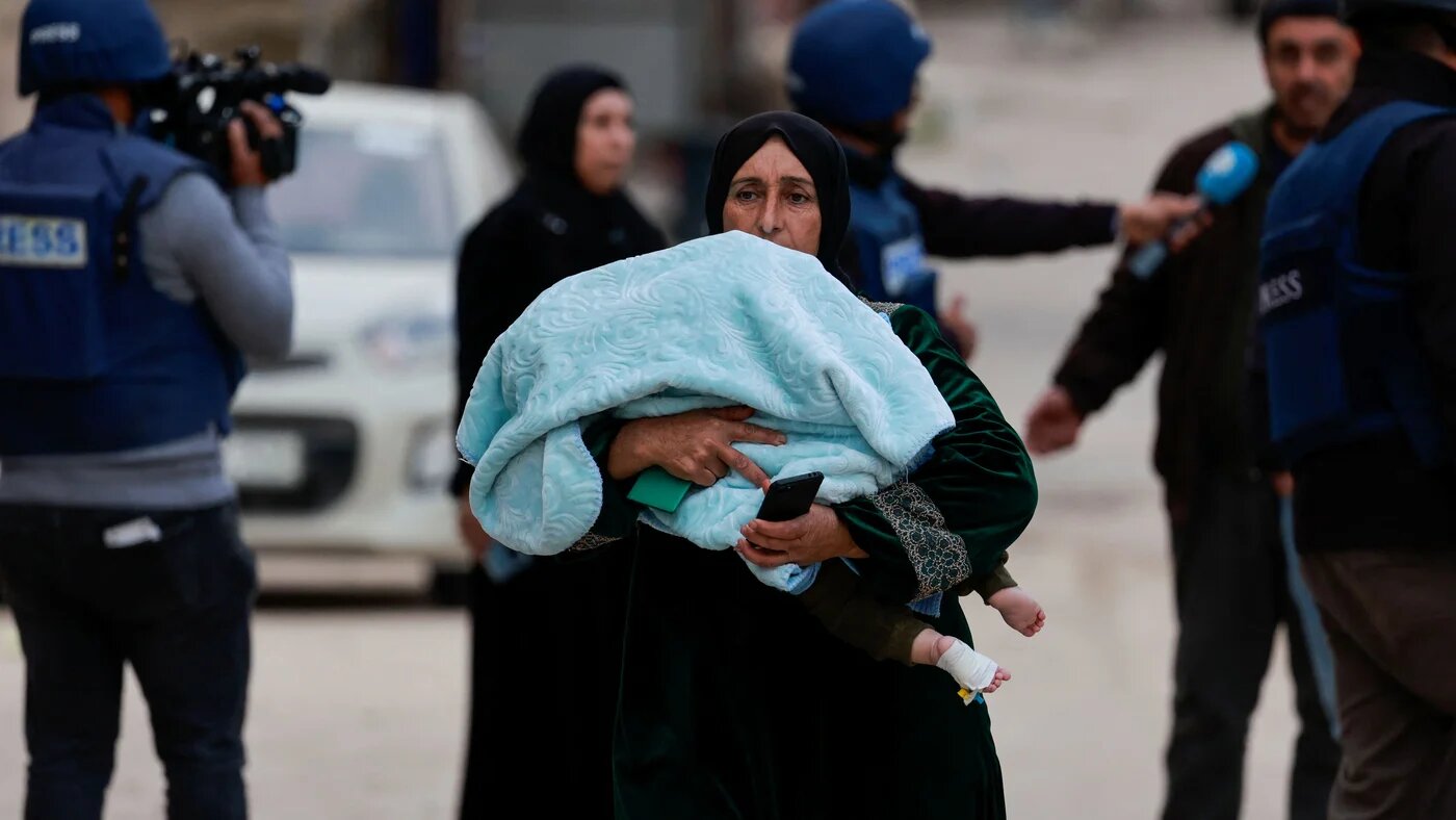Palestinians leave the Jenin camp, in the occupied West Bank, during an Israeli incursion on 22 January 2025 (Reuters/Ammar Awad)