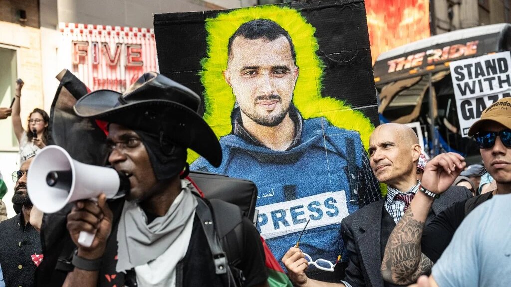 A person holds an image of a journalist killed in Gaza as Pro-Palestinian protesters participate in a "March for Humanity" against the humanitarian crisis in Gaza on 16 August, 2025 in New York City. (Stephanie Keith/Getty Images/AFP)