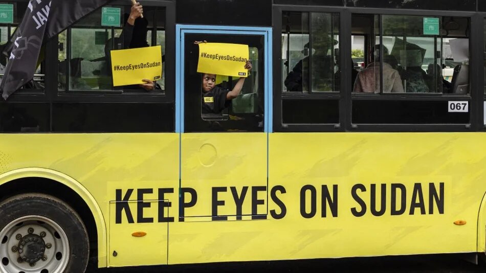 Activists ride in a bus bearing a message from Amnesty International advocating international action on the Sudan war, in Nairobi, Kenya, on 15 April 2026 (Tony Karumba/AFP)