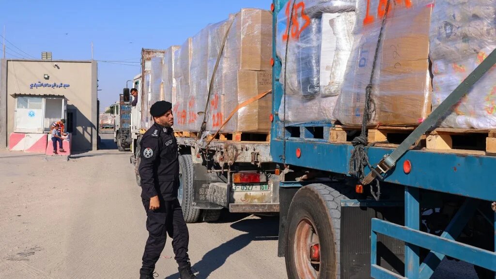 A Palestinian police officer searches a truck slated for export at the Kerem Shalom crossing in the southern Gaza Strip on 21 June 2021.
