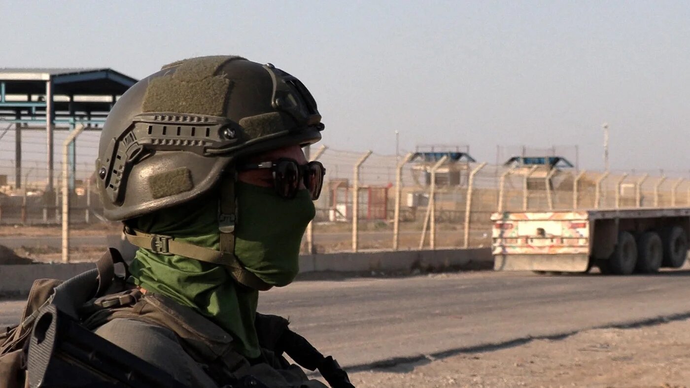 An Israeli soldier stand next to a truck at the Kerem Shalom crossing between southern Israel and the Gaza Strip on July 27, 2025. Carlos REYES / AFP