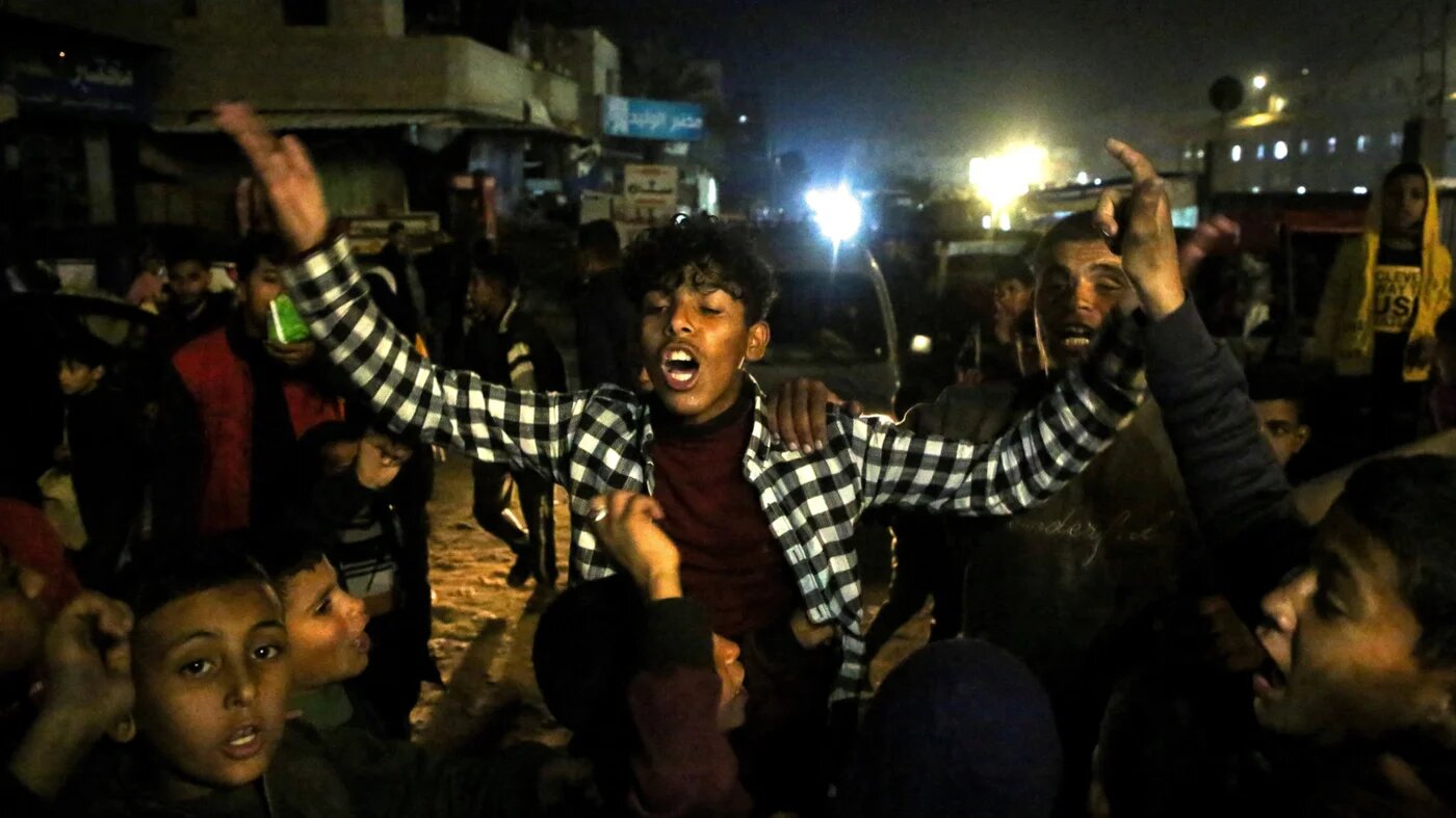 Palestinians react as they wait for news of a ceasefire deal with Israel, in Khan Younis in the southern Gaza Strip on 15 January 2025 (Hatem Khaled/Reuters)