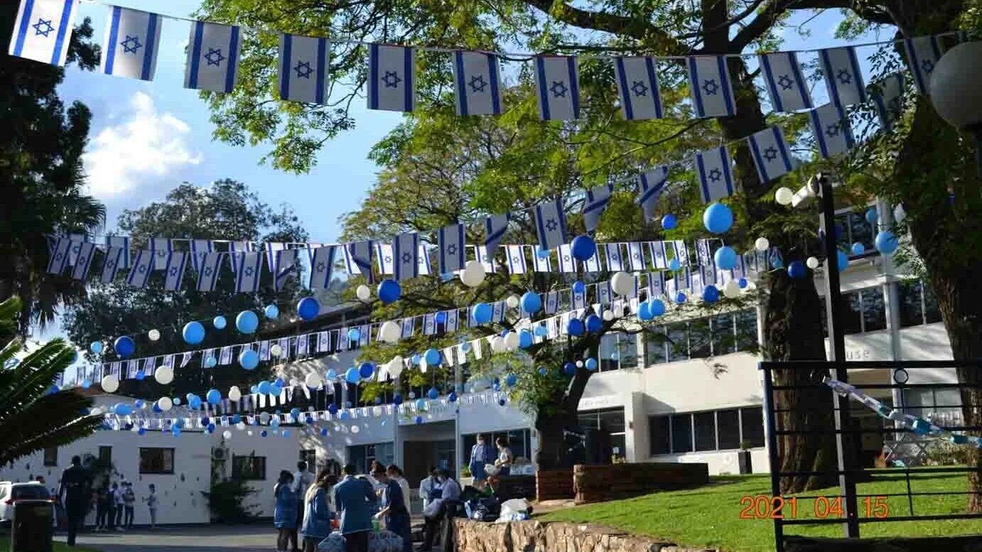 Israeli flags are displayed across the campus of King David High School in Johannesburg in 2021 (King David High School)
