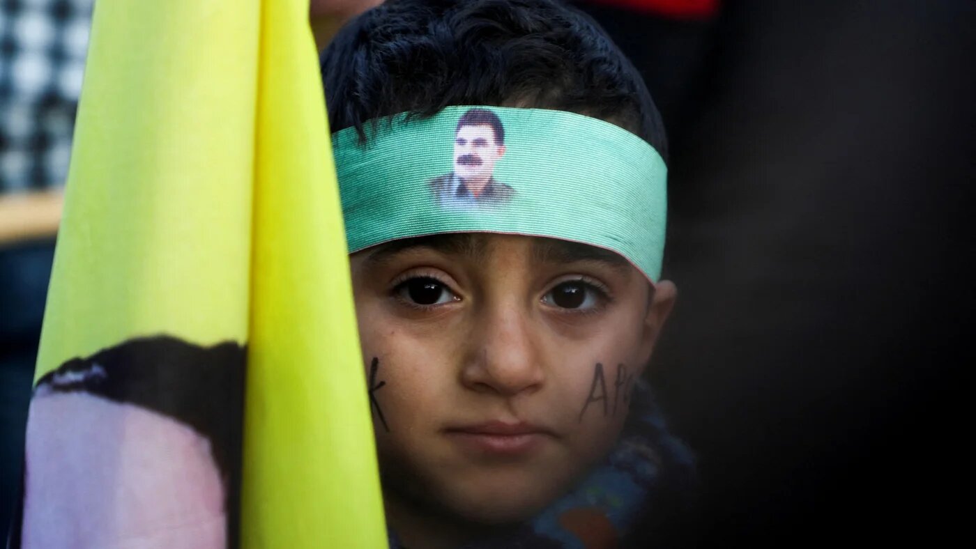 A child looks on while Syrian Kurds gather after Abdullah Ocalan called on his Kurdistan Workers' Party (PKK) to lay down its arms, in Hasakah, Syria 27 February (Reuters/Orhan Qereman)
