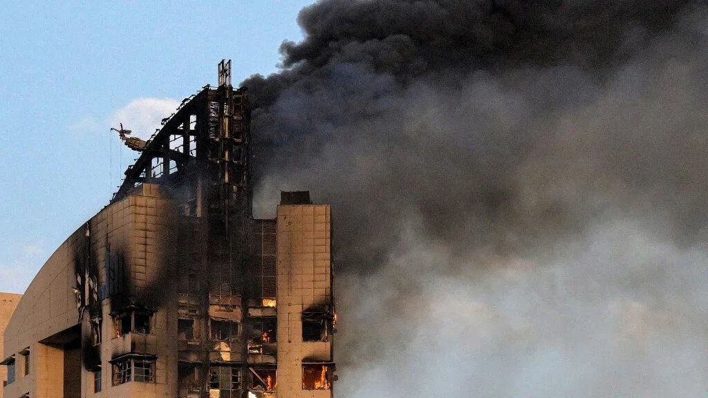 Smoke rises from a building after a drone attack in Kuwait City on 8 March 2026 (AFP)