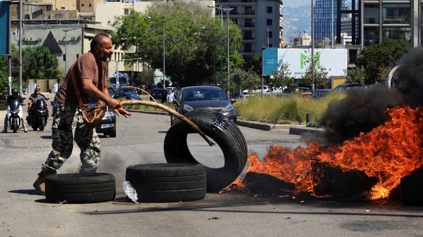 A retired Lebanese military person burns tyres during a protest opposing the draft 2027 state budget, which includes no increase in pension payments, amid the country's ongoing economic crisis, near government and parliament buildings in central Beirut, 9 September 2026 (Mohamed Azakir/Reuters)
