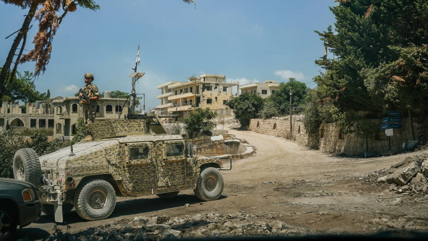 A Lebanese soldier stands guard at the entrance to Zawtar al-Gharbiyeh, one of three southern Lebanese villages designated as a “pilot zone” under an Israel-Lebanon framework agreement (Giovanna Vial/MEE)
