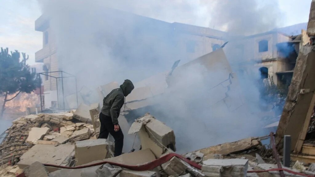 A man inspects the damage at the site of an Israeli air strike targeting the southern Lebanese village of Jbaa on 4 December 2025 (Mahmoud Zayyat/AFP)