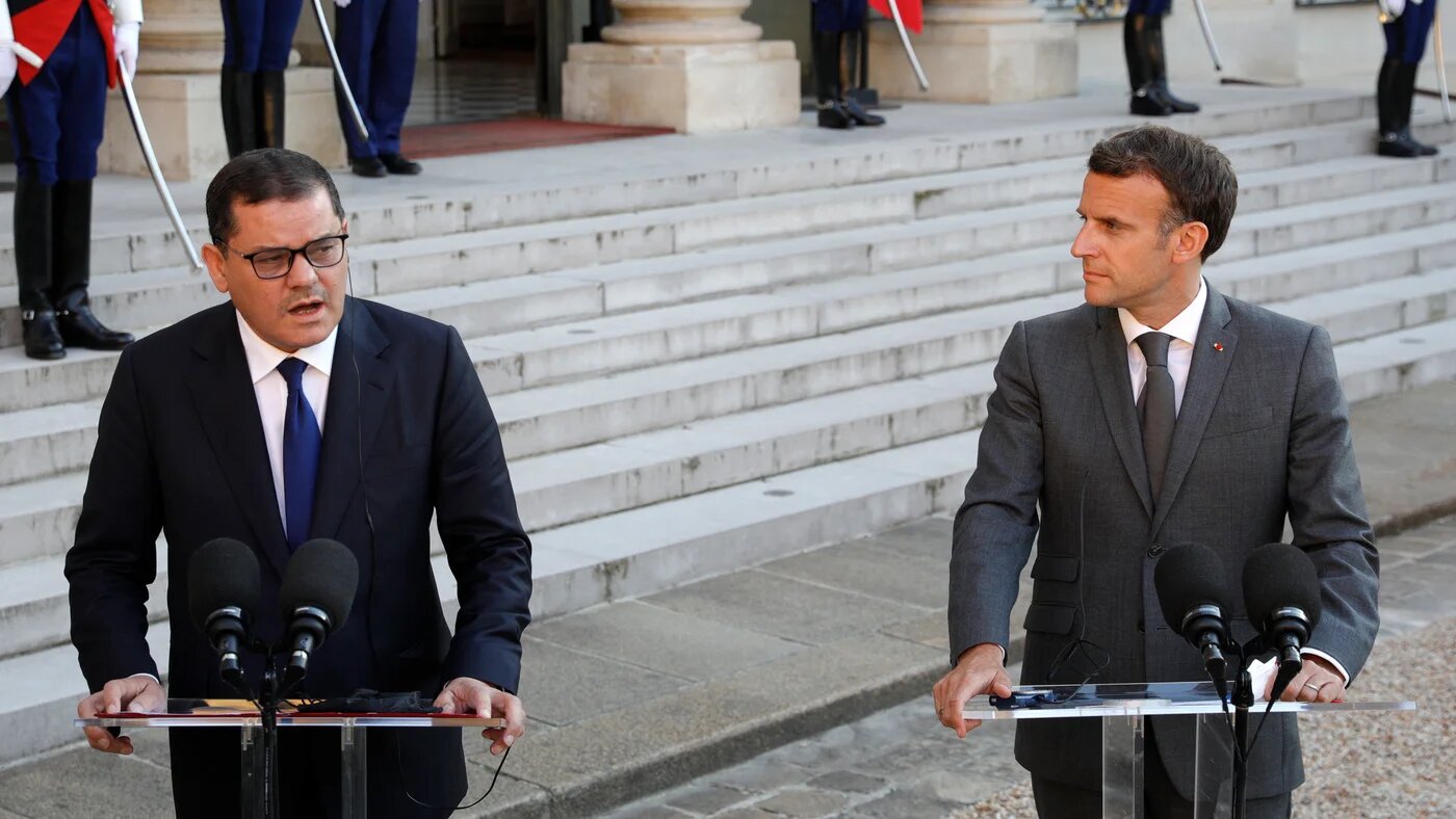 Libya's Interim Prime Minister Abdul Hamid Dbeibah (L) and French President Emmanuel Macron 