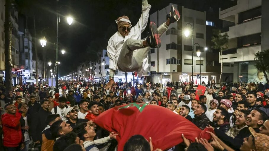Les fans des Lions de l’Atlas célèbrent, à Rabat, l’exploit de leur équipe devant le Portugal, le 10 décembre 2022 (AFP/Fadel Senna)