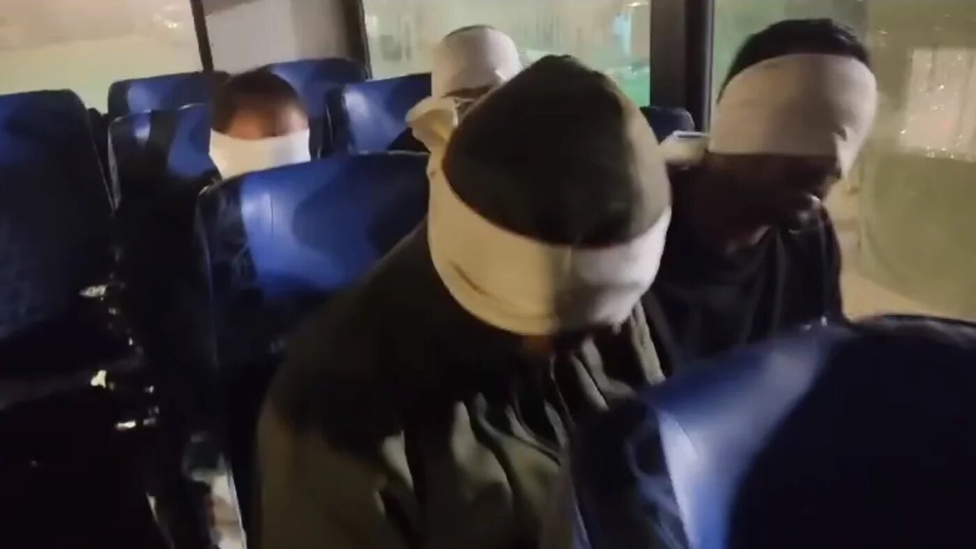 Blindfolded men sit on a bus and repeat Hebrew phrases, in footage shared on a far-right Israeli social media channel on 30 January 2024 (Telegram/Screengrab)