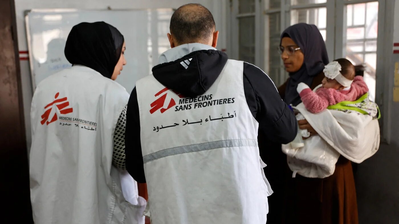 A Palestinian woman arrives with a child at the Doctors Without Borders (MSF) clinic, in the al-Rimal neighbourhood of Gaza City on 31 December 2025 (AFP/Omar al-Qattaa)