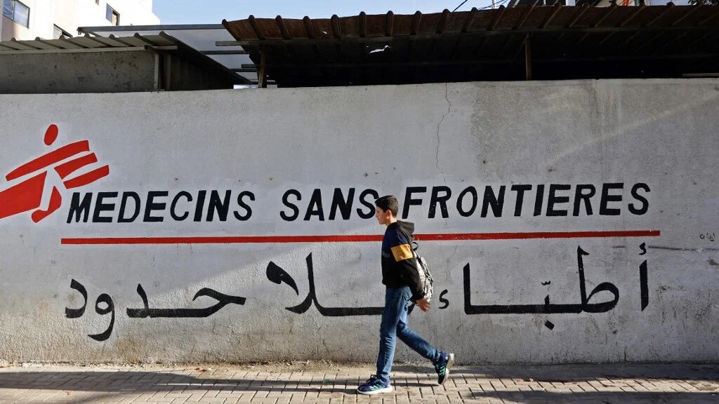 A Palestinian boy walks past a clinic run by Doctors Without Borders (MSF) in the al-Rimal neighbourhood of Gaza City on 11 January 2026 (AFP)