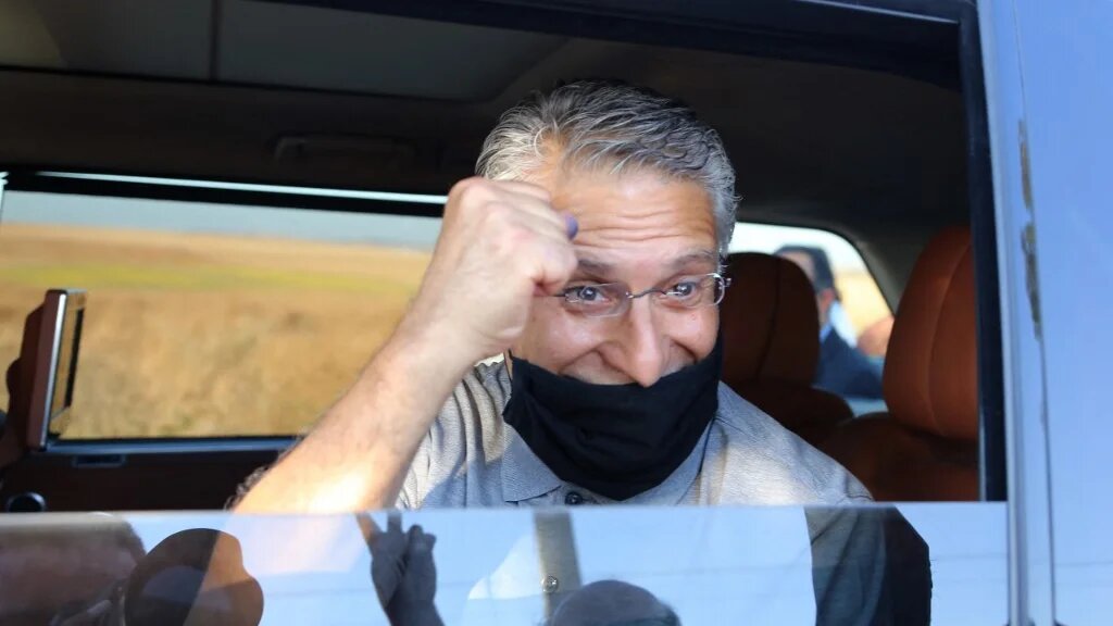 Tunisia's former presidential candidate Nabil Karoui waves to well wishers as he leaves the prison in Tunis following his release on 15 June 2021.