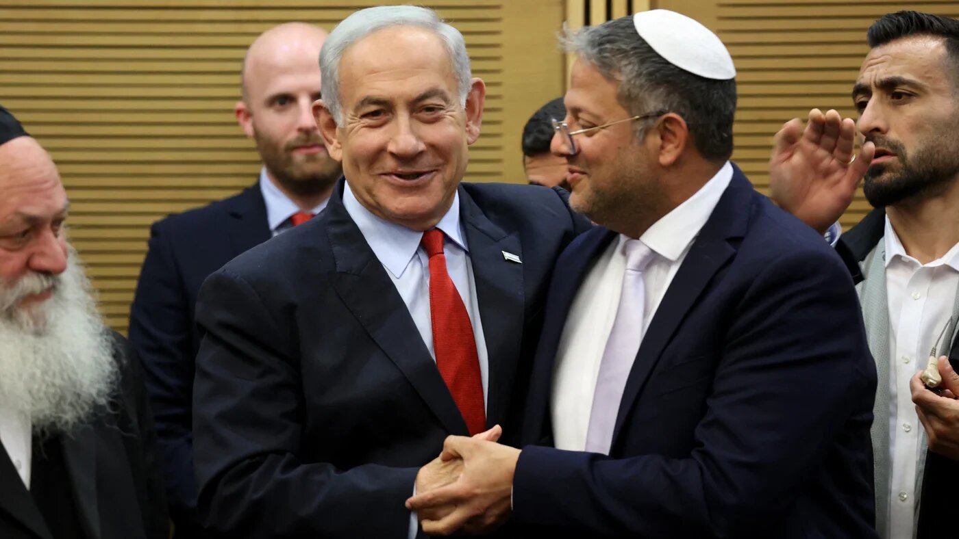 Israeli Prime Minister Benjamin Netanyahu (L) greets National Security Minister Itamar Ben Gvir at the parliament in Jerusalem, 23 May 2023 (AFP)