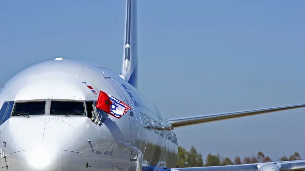 Les drapeaux du Maroc, d’Israël et des États-Unis sur un avion El Al après l’atterrissage à Rabat, du premier vol commercial direct Israël-Maroc, le 22 décembre 2020 (AFP)