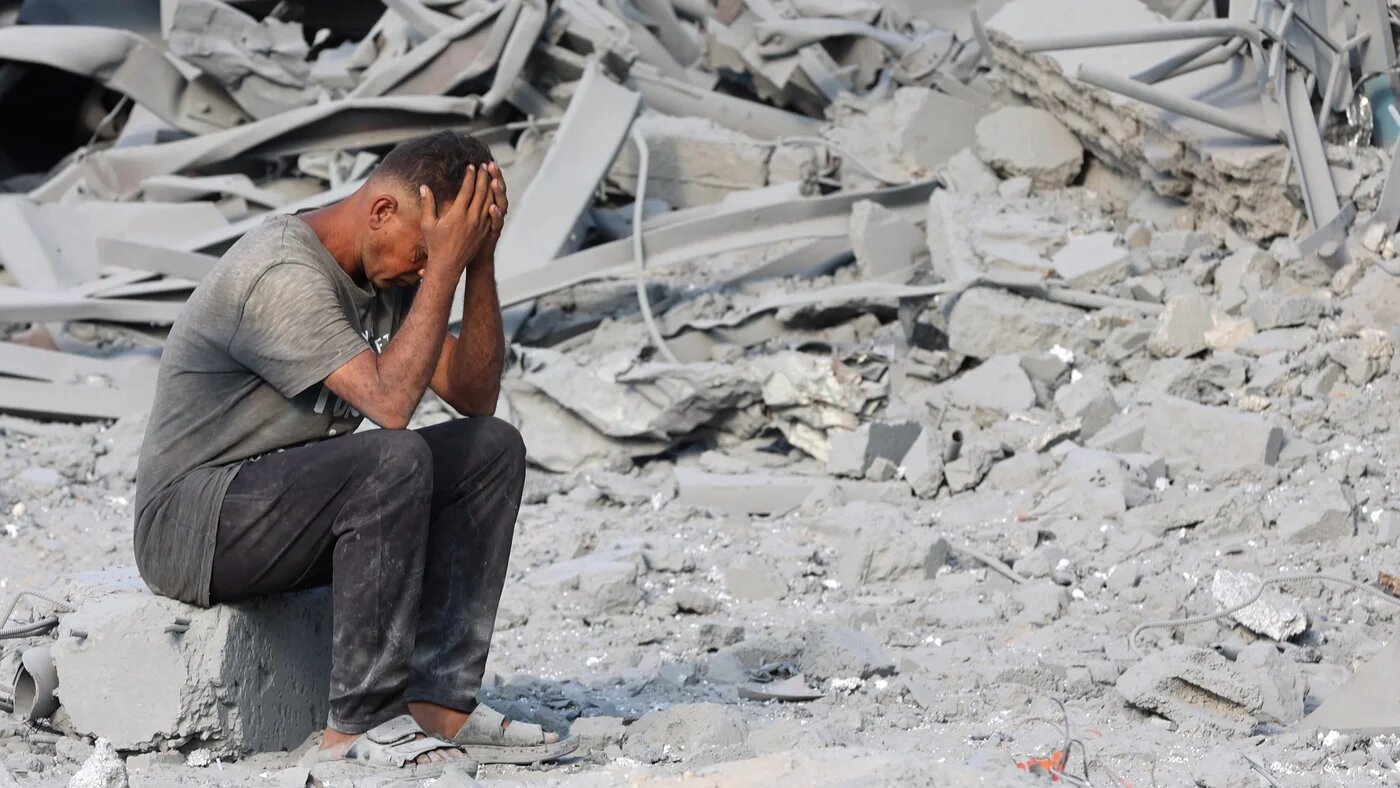 A Palestinian man reacts to the destruction after an overnight strike on the Sheikh Radwan Health Centre, north of Gaza City, on 6 August 2025 (AFP/Omar al-Qattaa)