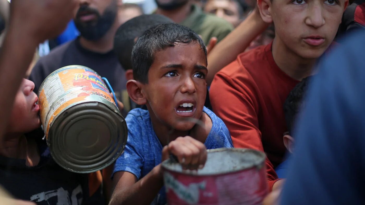 Palestinian children wait for food at an aid distribution point in Nuseirat, central Gaza, on 11 June, 2025 (AFP/Eyad Baba)