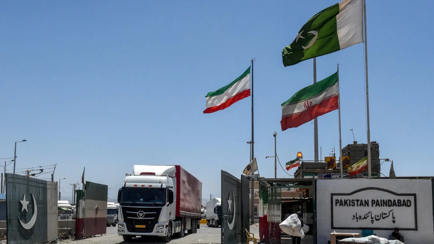Iranian cargo trucks cross into the Pakistan-Iran border at Taftan, Balochistan province on 18 June 2025 (Banaras Khan/AFP)