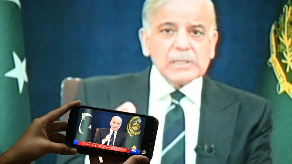 A resident watches an address by Pakistani Prime Minister Shehbaz Sharif about the US-Israeli conflict with Iran, in Islamabad on 9 March 2026 (Aamir Qureshi/AFP)